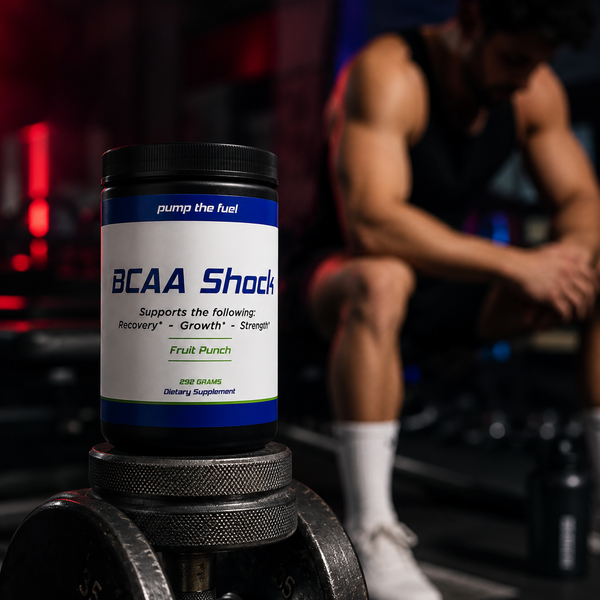 Pump The Fuel BCAA Shock fruit punch supplement displayed with dumbbells in a gym recovery setting