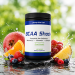 Pump The Fuel BCAA Shock fruit punch supplement surrounded by fresh berries, citrus fruit and water splashes