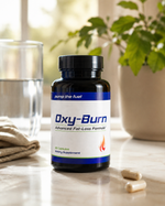 Pump The Fuel Oxy-Burn dietary supplement bottle beside water and capsules in a bright wellness lifestyle setting