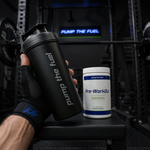Pump The Fuel Tropical Sunrise pre-workout powder with branded shaker bottle in a weight training gym